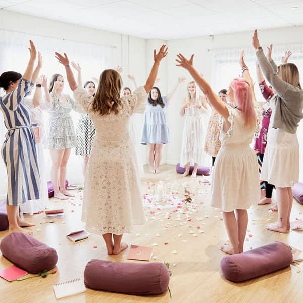 Group of women raising their hands